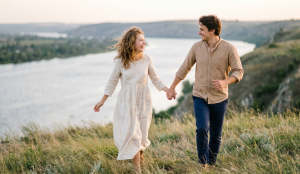 Фотостудія чи природа: що обрати для Love Story в Миколаєві Щаслива закохана пара тримається за руки під час прогулянки мальовничими схилами біля річки. Ідеї для лав сторі на природі від фотографа Вікторії Чистікової у Миколаєві